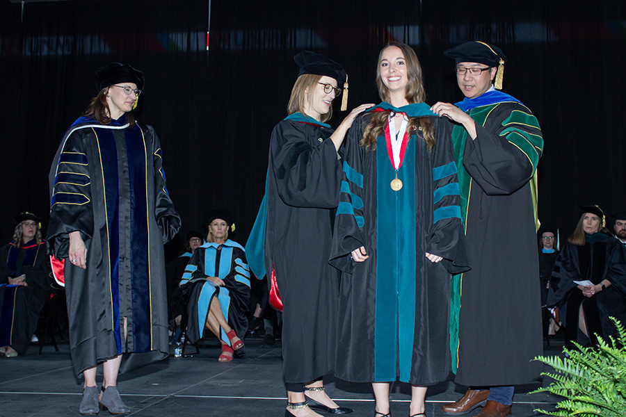 PT student being hooded