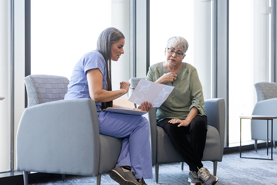 A psychiatric mental health nurse practitioner works with a patient.