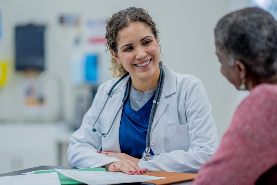 Physician works with patient. 