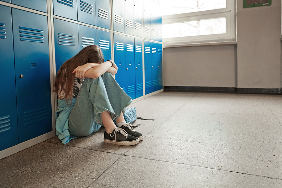 Student cries near locker.