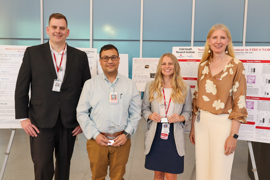 Winning poster researchers photographed with Dr. Ann Anderson Berry