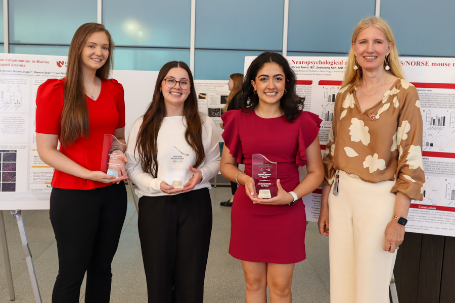 Winning poster researchers photographed with Dr. Ann Anderson Berry