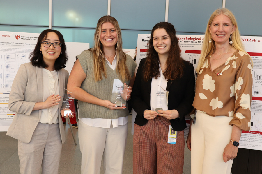 Winning poster researchers photographed with Dr. Ann Anderson Berry