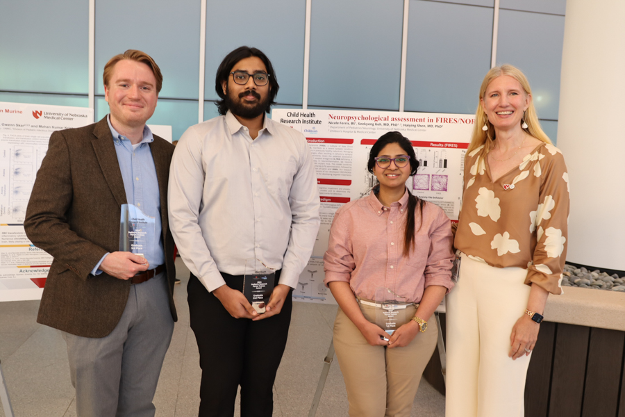 Winning poster researchers photographed with Dr. Ann Anderson Berry