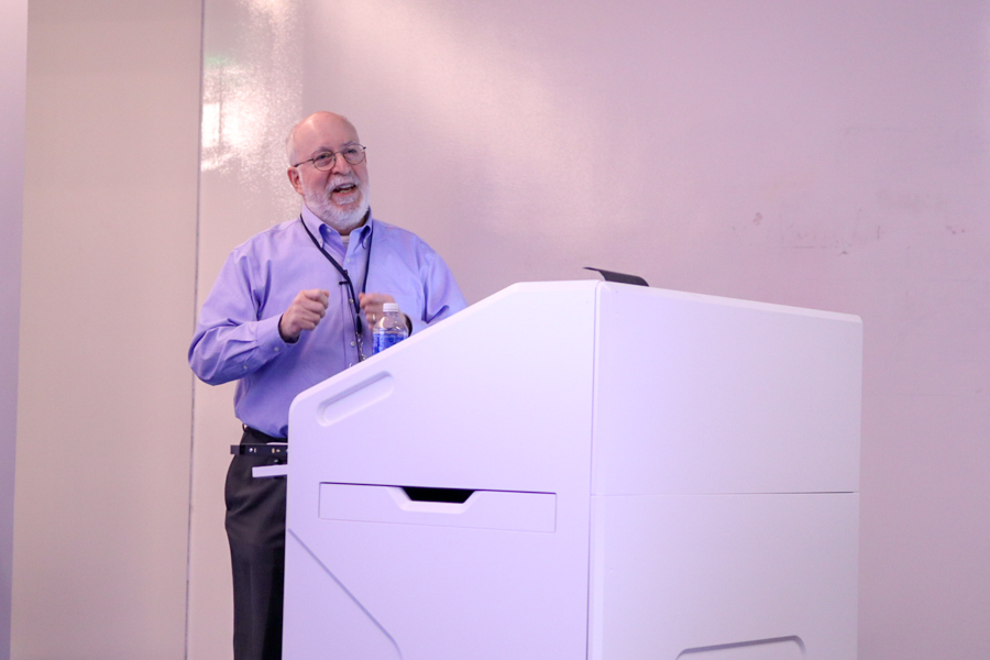 man speaking behind a podium