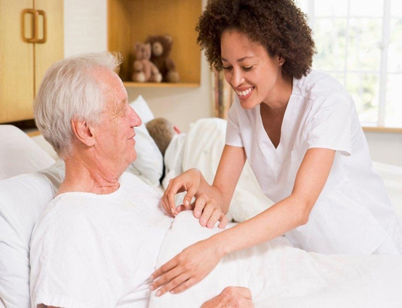 A nurse checks a patient's vitals.