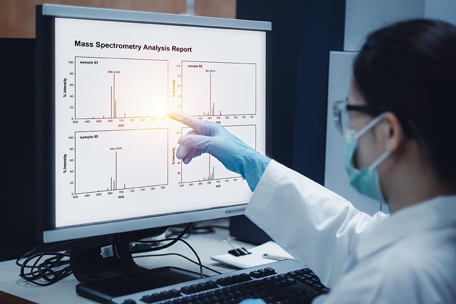 Scientist reviews mass spectrometry results.