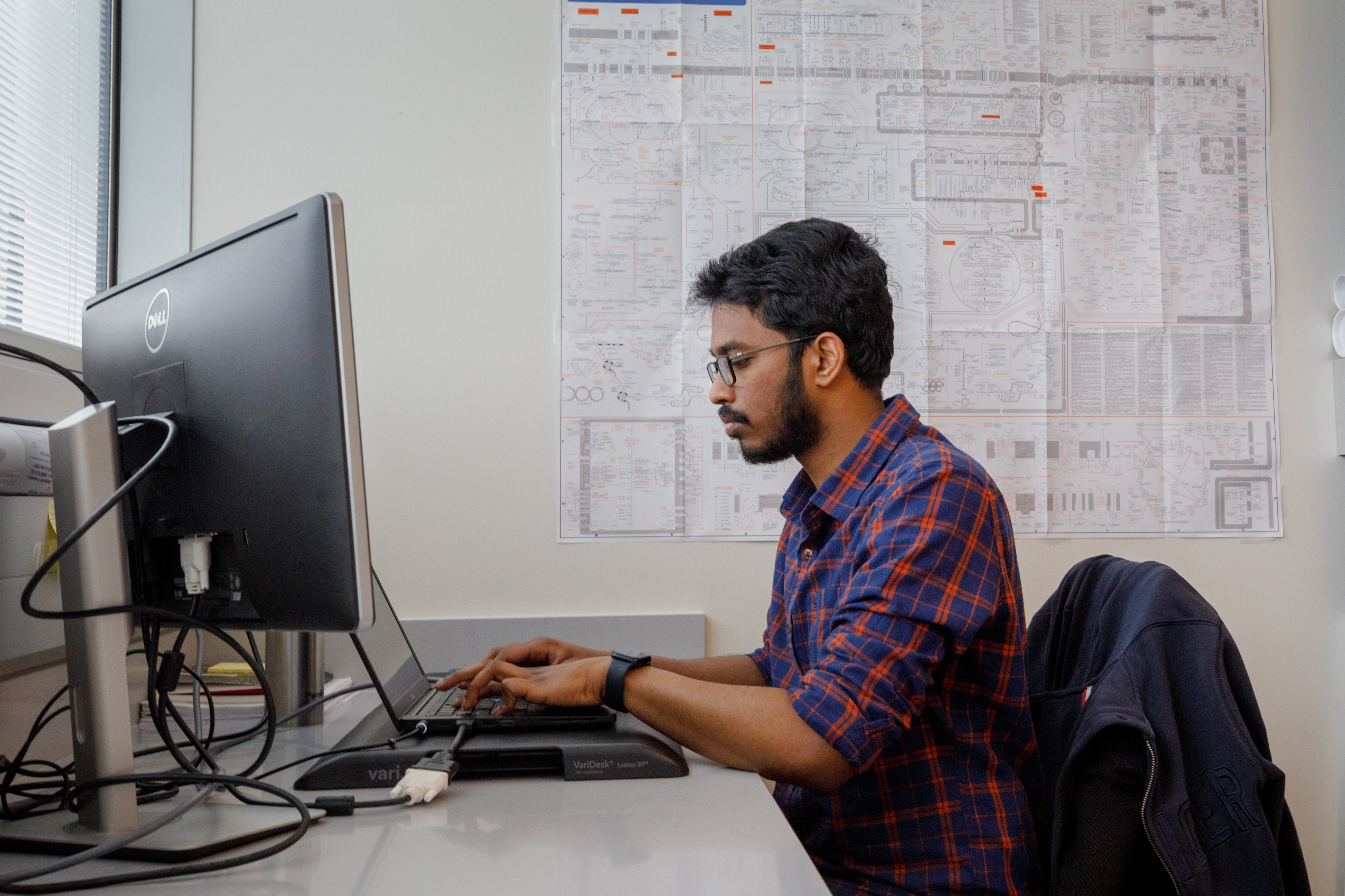 Two students consult a digital screen