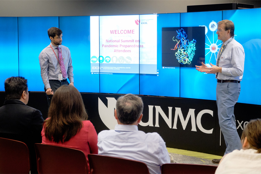 Students presenting in front of an interactive screen