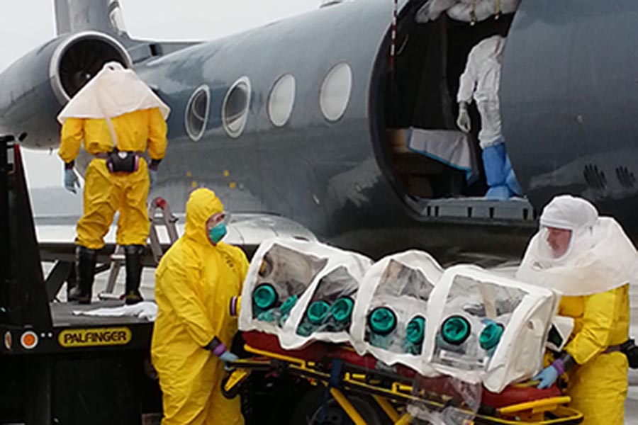 A person in an isolation unit is removed from a plane in Omaha.