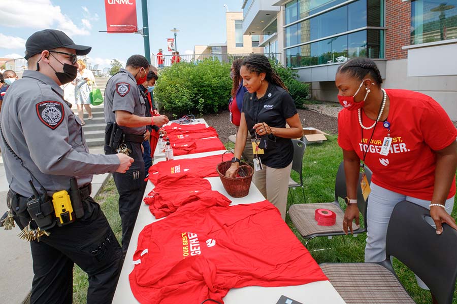 UNMC security officers check in with staff members at a campus barbecue.