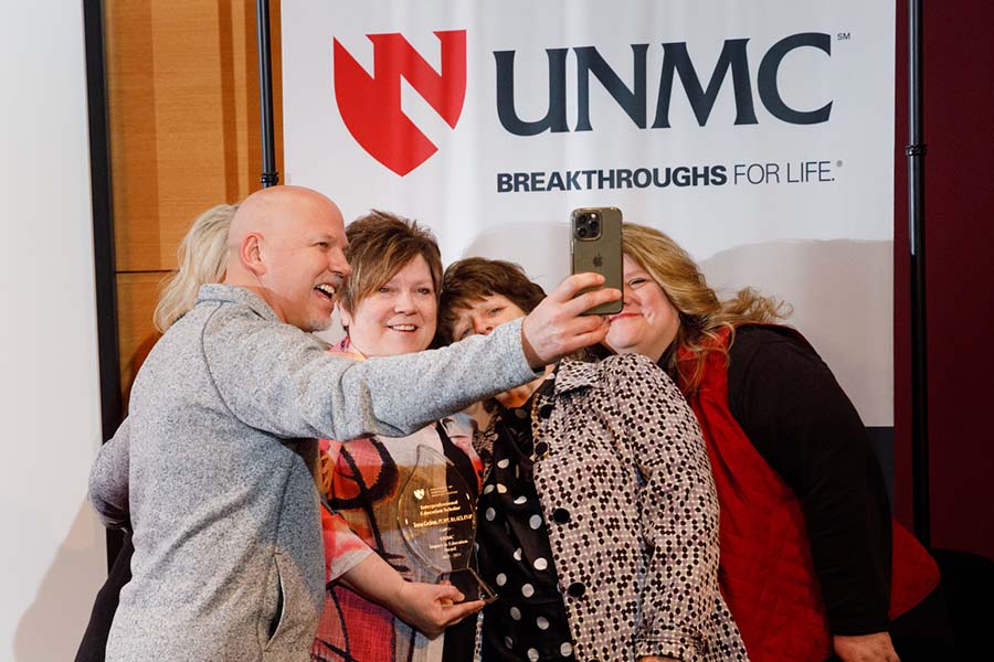 UNMC employees celebrate an award with a selfie.