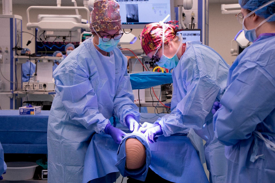 Students learn OR dental protocol – throat packs and periodontal debridements – from Corinne Van Osdel, DDS, an assistant professor, and Andrea Auer, a dental assistant supervisor, both at the UNMC College of Dentistry.