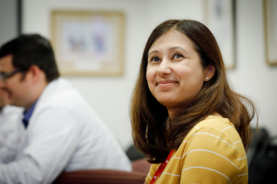 Elizabeth Harlow, MD, working at a computer with a colleague..