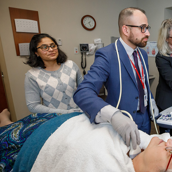 Drs. Kharbanda, and Kotwal doing a thyroid ultrasound on a patient.