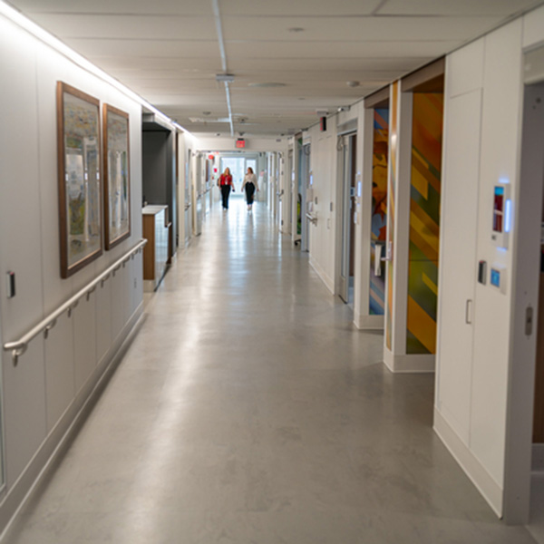 Two health care workers walk down the hallway in the new Innovation Design Unit.