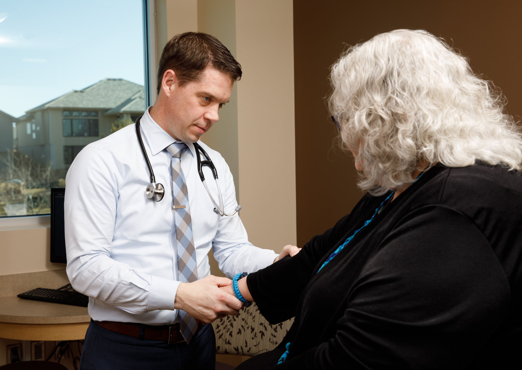 Dr. Marcus Snow of the UNMC Division of Rheumatology examines a patient.