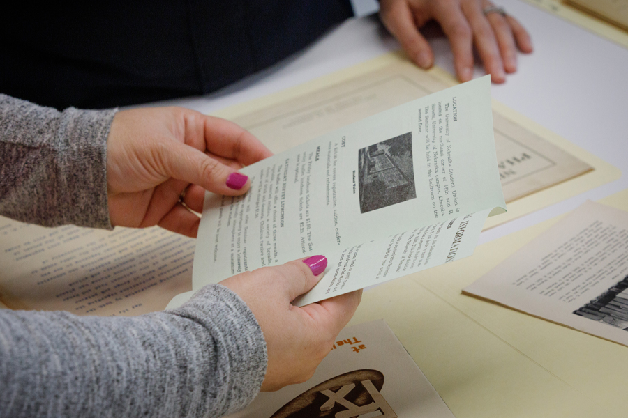 Library staff holding pamphlet from the archives collection