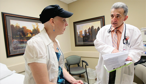 Mehmet Sitki Copur, M.D., medical director of the St. Francis Cancer Center, Grand Island, Neb., with a cancer patient.