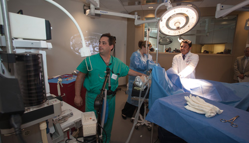 James Sullivan, M.D., assistant professor, anesthesiology; Jennifer Adams, M.D., assistant professor, anesthesiology; and Chandra Are, M.B.B.S., associate professor, surgical oncology, demonstrate the surgical simulation suite capabilities during the dedication ceremony.