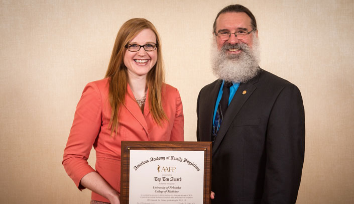 Shelley Baldwin, administrator in the UNMC Department of Family Medicine, accepts the award on behalf of the department from AAFP President Reid Blackwelder, M.D.