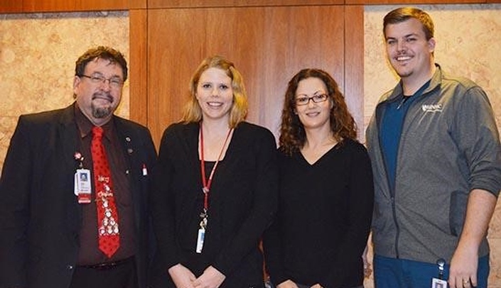 From left: MMI Director Karoly Mirnics, M.D., Ph.D., poses with Amber Godsey, Michelle Young-Oestmann and Andrew Sodawasser.