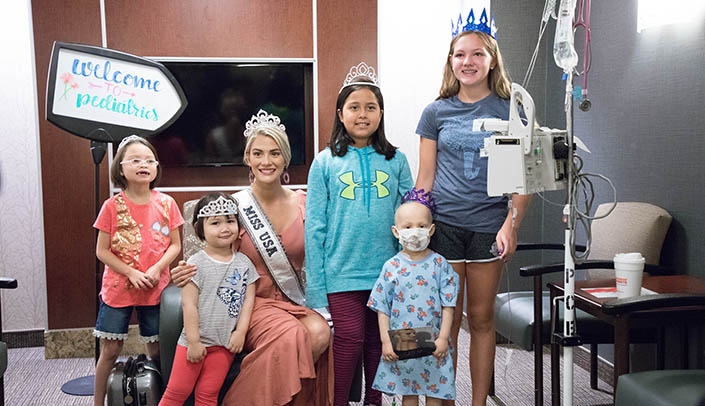 Miss USA, Nebraska's own Sarah Rose Summers, poses with pediatric patients during her visit this month to UNMC/Nebraska Medicine.
