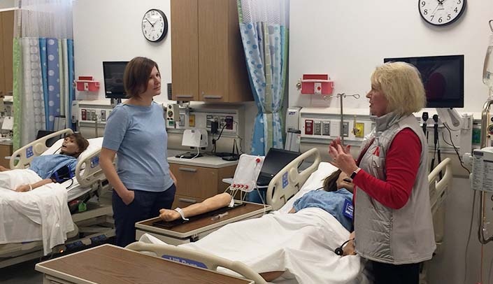 State Sen. Kate Bolz, left, speaks with Rita Schmitz, assistant professor, during her tour of the Lincoln Division of the College of Nursing.