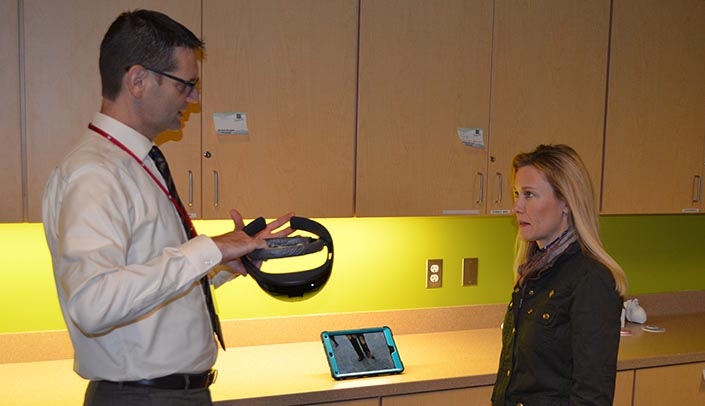 Ben Stobbe (left), executive director of clinical simulation, explains the HoloLens to State Sen. Theresa Thibodeau.