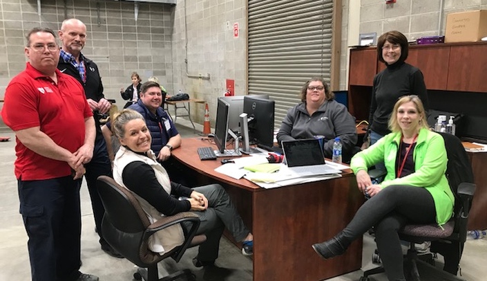 Pat O'Neil (second from right) is directing the Flood Relief Donation Management Center. She is seen here with members of the Field Innovation Team, a non-profit relief organization that is assisting in managing the donation center.