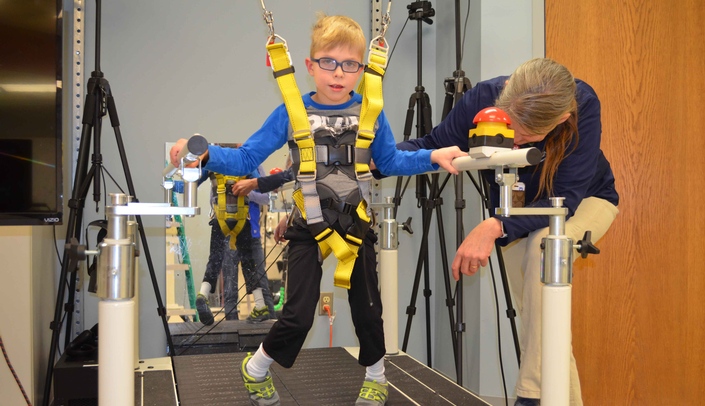 Wyatt Fisher, a 6-year-old from Ravenna, Neb., walks on the treadmill in the Munroe-Meyer Institute's Sensorimotor Learning Lab on the UNMC campus.