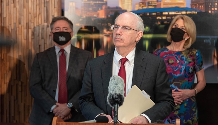 UNMC Chancellor Jeffrey P. Gold, MD, center, speaks at the press conference Tuesday as Omaha Mayor Jean Stothert, right, and Steve Curtiss, finance director, left, look on.