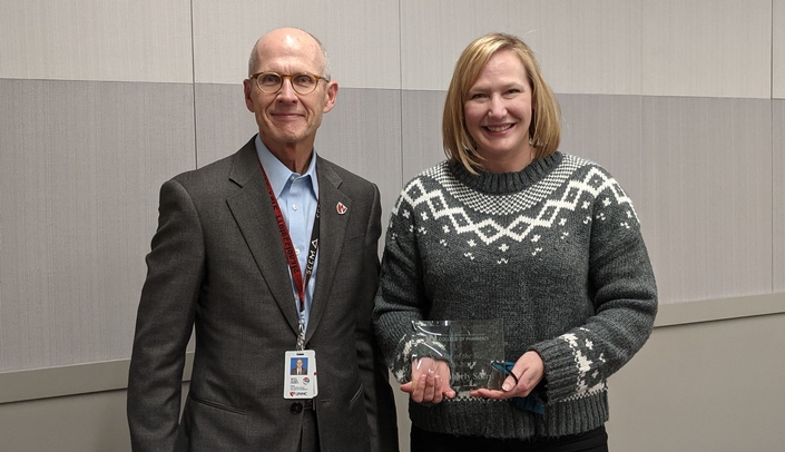 Kim Scarsi, PharmD, who received the College of Pharmacy's Scholar of the Year honor, is pictured with Keith Olsen, PharmD, dean of the college.