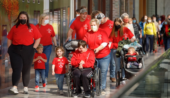 The B Strong team, led by Brandon Herting and mom Barb, walks and rolls around Oak View Mall at the March 6 Walk & Roll for Disabilities.
