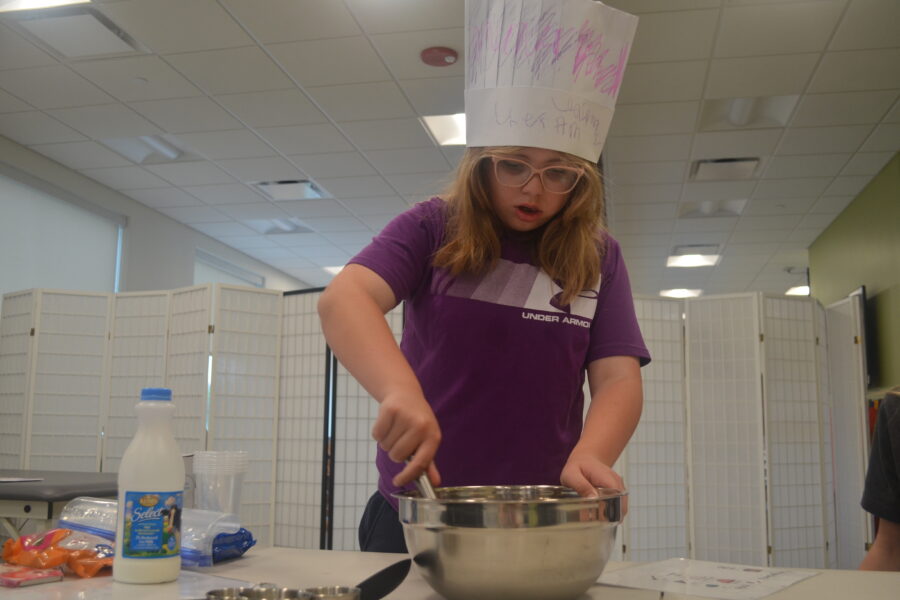 Leah Raak takes a turn whisking pudding ingredients together during a camp session&period;
