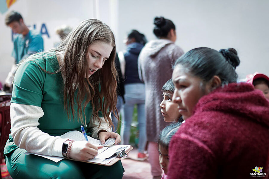 UNK student Kennady Schmidt works with a family during a medical outreach trip to Peru&period; Students assisted at six mobile medical clinics during their two-week stay&period; &lpar;Courtesy photo&rpar;