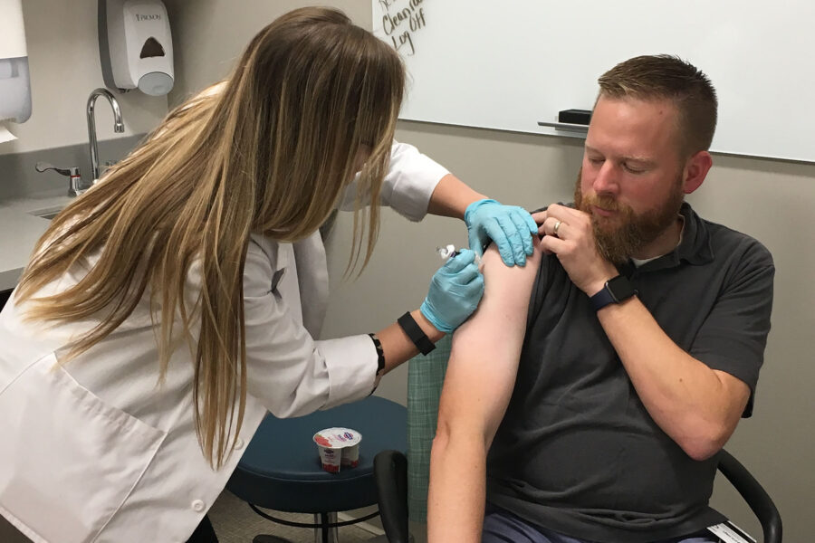 Don Klepser&comma; PhD&comma; senior associate dean for academic affairs for the UNMC College of Pharmacy and a professor of pharmacy practice and science&comma; receives a flu shot through the college&apos;s "Operation Immunization&period;"