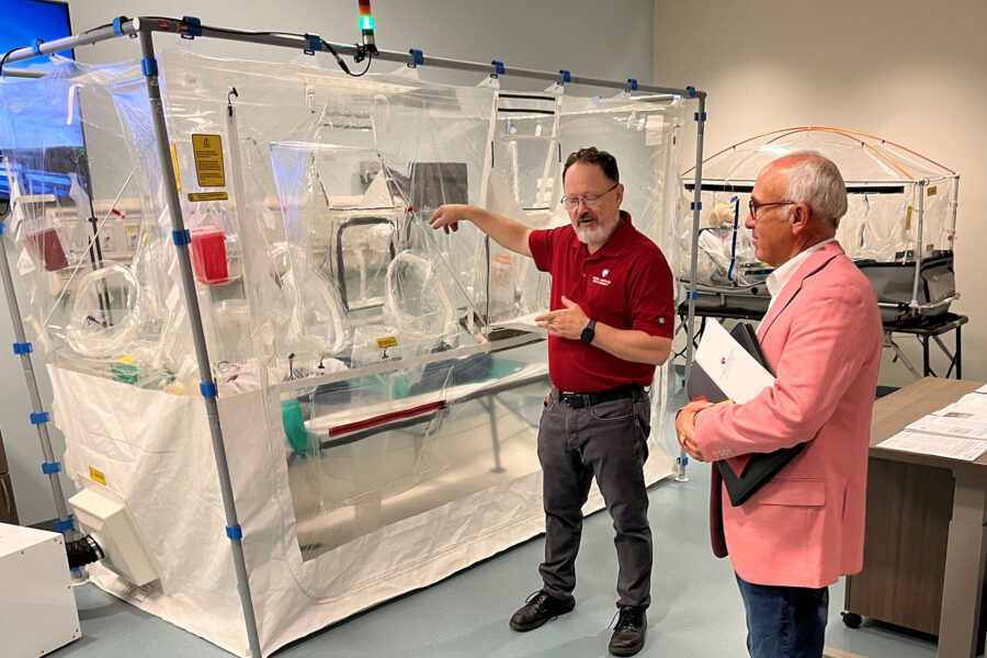 Tony Sorrentino hears a presentation from Mark Vazquez&comma; program manager with the Global Center for Health Security&comma; on UNMC&apos;s ISTARI portable negative pressure containment patient care system&period;