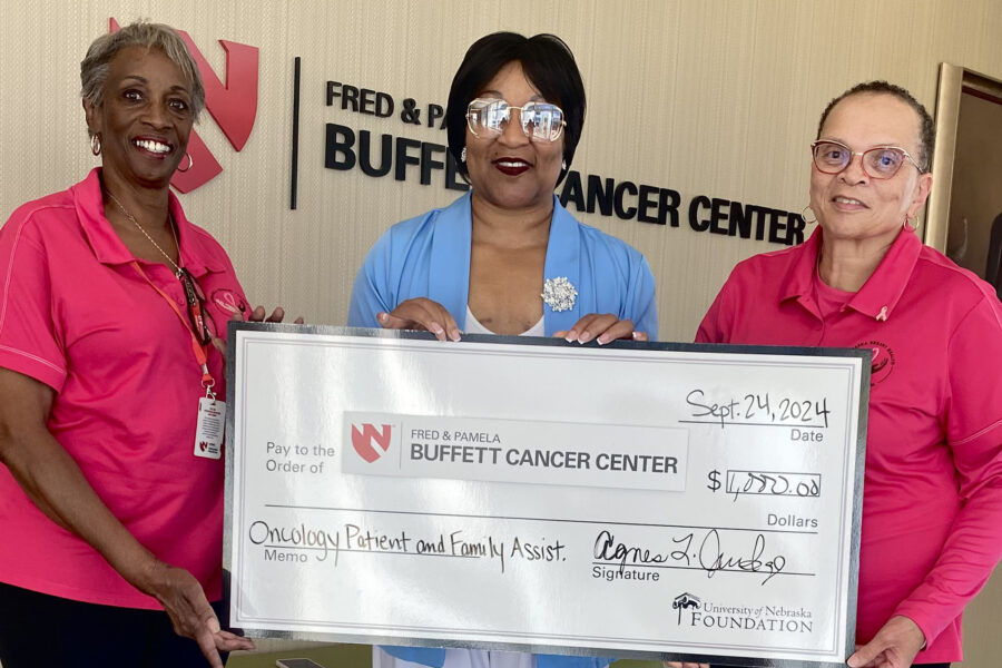 Breast cancer survivor Agnes Judge &lpar;center&rpar; contributed to the Oncology Patient and Family Assistance Fund on her visit to the Fred & Pamela Buffett Cancer Center&period;