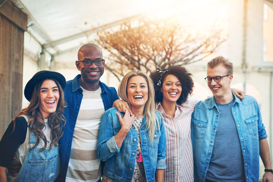 Group of five young people smiling