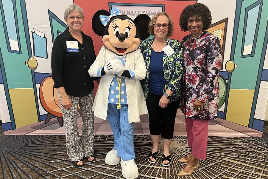 Linda Herrick&comma; PhD&comma; Teresa Hulquist&comma; PhD&comma; and Lepaine Sharp-McHenry&comma; DNP&comma; UNMC College of Nursing dean&comma; had a photo-op with Minnie Mouse at site evaluator training earlier this year&period;