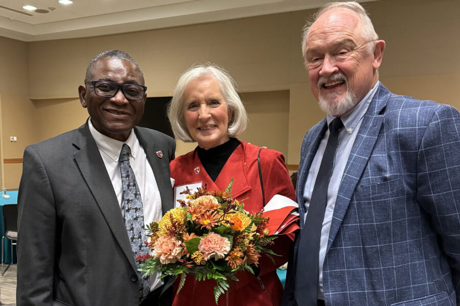 Interim UNMC Chancellor H&period; Dele Davies&comma; MD&comma; greets Board of Counselors Chair Barbara Bartle and her husband&comma; Bob&period;