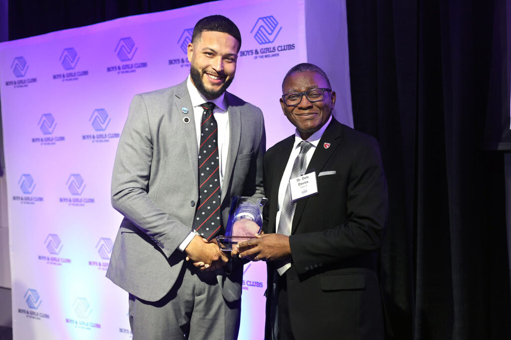 Richard Webb, president and CEO of Boys & Girls Clubs of the Midlands, congratulates UNMC Interim Chancellor H. Dele Davies, MD.