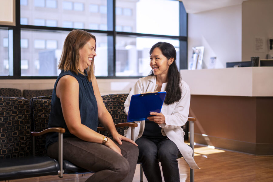 A stock image of a physician speaking with a patient