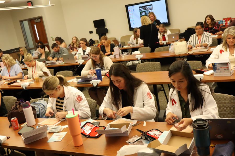 Graduate nursing students learning sutures