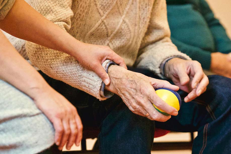 Man holding a therapy ball.