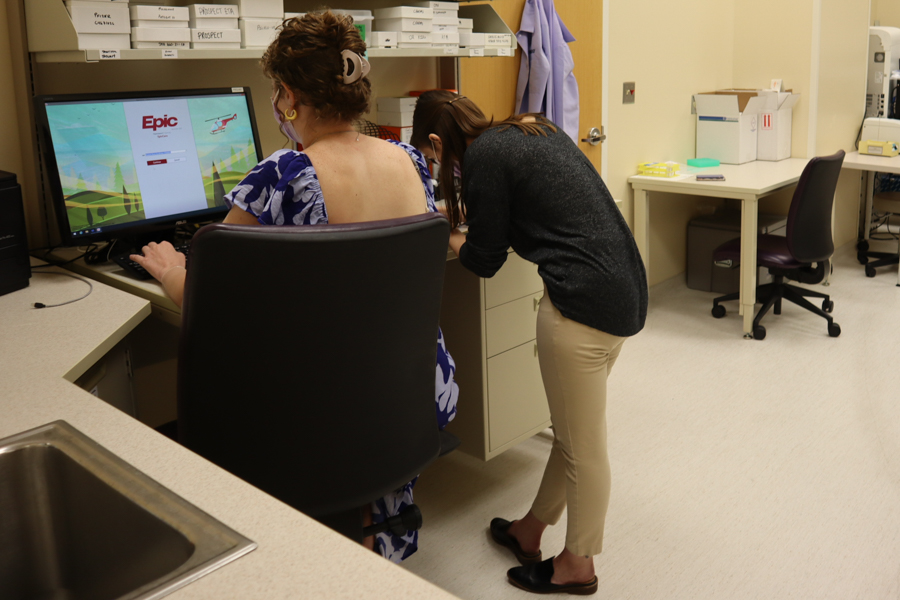 two women working in lab with back  to camera