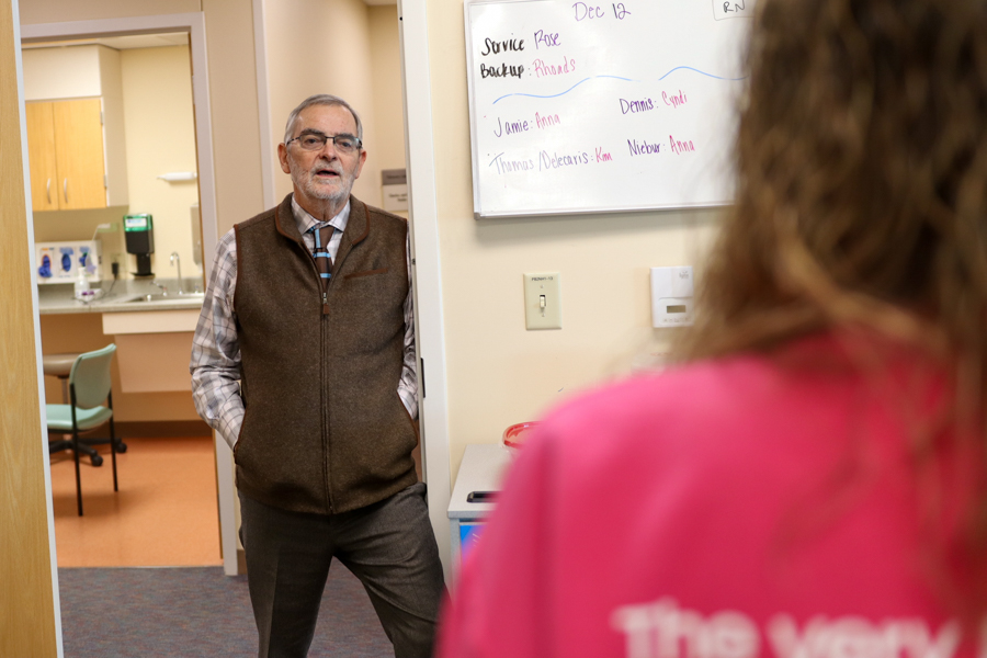 doctor talking to person while standing in a doorway