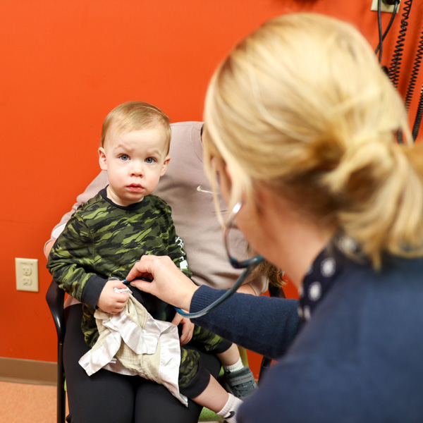 child being treated  by female doctor