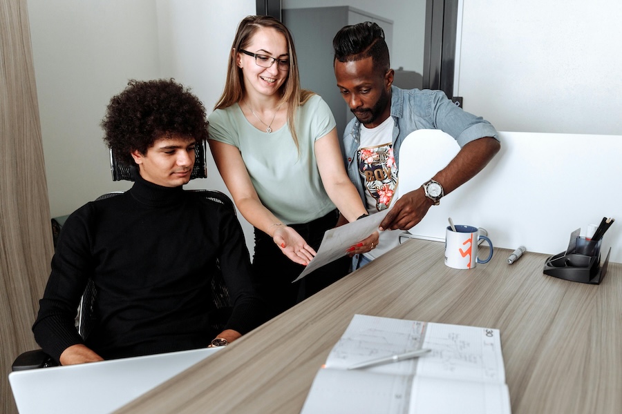 A group of students at a desk. 